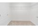 Empty walk-in closet with carpeted floor, white walls and shelving at 917 Jackson Ave, Davenport, FL 33837
