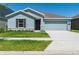 Charming single-story home with a well-manicured lawn and two-car garage at 917 Jackson Ave, Davenport, FL 33837