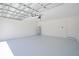 Garage features a water heater, door to the exterior, and painted concrete floor at 917 Jackson Ave, Davenport, FL 33837