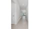 Bright, neutral hallway featuring tile flooring and access to various rooms at 917 Jackson Ave, Davenport, FL 33837