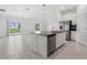 Modern kitchen with stainless steel appliances, island with sink, and an open floor plan at 917 Jackson Ave, Davenport, FL 33837