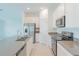 Modern kitchen with stainless steel appliances, island with sink, white cabinets at 917 Jackson Ave, Davenport, FL 33837