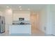 Bright kitchen with white cabinets, stainless steel appliances and island at 917 Jackson Ave, Davenport, FL 33837