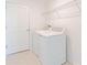 Clean laundry room features a washer, dryer, and wire rack shelving for storage solutions at 917 Jackson Ave, Davenport, FL 33837