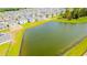 Aerial view of a neighborhood next to a serene pond and lush greenery at 921 Jackson Ave, Davenport, FL 33837