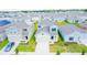 Aerial view of a new residential neighborhood with similar two-story homes, green lawns, and ample parking at 921 Jackson Ave, Davenport, FL 33837