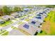 Aerial view of a neighborhood with solar panels, sidewalks, and landscaping at 921 Jackson Ave, Davenport, FL 33837