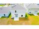 This home features a grassy backyard and an outdoor patio at 921 Jackson Ave, Davenport, FL 33837