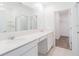 A modern bathroom featuring double sinks, a large mirror, white cabinets, and a glass-enclosed shower at 921 Jackson Ave, Davenport, FL 33837