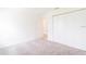 This bedroom features neutral carpet, white walls, and a closet at 921 Jackson Ave, Davenport, FL 33837