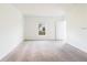 A spacious bedroom with neutral carpet, bright window, and a white door and trim at 921 Jackson Ave, Davenport, FL 33837