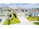 Aerial view of a well-maintained two-story home with green lawn, spacious driveway, and a neatly landscaped yard at 921 Jackson Ave, Davenport, FL 33837