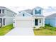 Charming two-story home with a large garage and neatly manicured lawn in a Gathering-friendly neighborhood at 921 Jackson Ave, Davenport, FL 33837