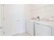 This laundry room features new washer and dryer units, plus convenient shelving at 921 Jackson Ave, Davenport, FL 33837