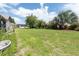 Spacious backyard with lush green grass, mature trees, and plenty of room for outdoor activities at 935 Amy Ridge Ct, Kissimmee, FL 34747
