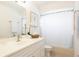 Bright bathroom with a white vanity, framed art, and a shower-tub combination for convenience at 935 Amy Ridge Ct, Kissimmee, FL 34747