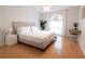 Bright bedroom with a large window, a modern bed frame, and a dedicated workspace with desk and chair at 935 Amy Ridge Ct, Kissimmee, FL 34747