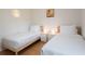 Shared bedroom featuring two twin beds with wooden frames, and minimalistic decor at 935 Amy Ridge Ct, Kissimmee, FL 34747