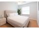 Comfortable bedroom with a plush bed, a window for natural light, and a calming plant at 935 Amy Ridge Ct, Kissimmee, FL 34747