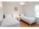 Bright bedroom features twin beds with wooden frames, minimalist lighting, and a comfortable setting at 935 Amy Ridge Ct, Kissimmee, FL 34747