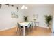 Bright dining room featuring modern table and chairs, plants, and natural light at 935 Amy Ridge Ct, Kissimmee, FL 34747
