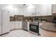 Bright kitchen featuring white cabinets, stainless steel appliances, and tiled backsplash at 935 Amy Ridge Ct, Kissimmee, FL 34747