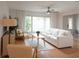 Cozy living room with abundant natural light, ceiling fan, and modern furnishings at 935 Amy Ridge Ct, Kissimmee, FL 34747