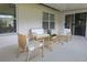 Covered patio featuring stylish wicker furniture, perfect for outdoor lounging and entertaining at 935 Amy Ridge Ct, Kissimmee, FL 34747