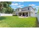 Expansive backyard with lush lawn, a privacy fence, outdoor seating, and patio, ideal for entertaining at 9963 Hartford Maroon Rd, Orlando, FL 32827