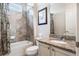 Bathroom featuring a tiled shower and tub combination, vanity with granite countertop, and modern fixtures at 9963 Hartford Maroon Rd, Orlando, FL 32827