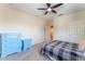 Cozy bedroom featuring a ceiling fan, carpet, and blue furniture set with modern black and white bedding at 9963 Hartford Maroon Rd, Orlando, FL 32827
