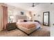 Comfortable bedroom features a tufted headboard, soft lighting, and soothing color palette at 9963 Hartford Maroon Rd, Orlando, FL 32827