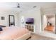 Spacious bedroom features a media center, full-length mirror, and ensuite bathroom at 9963 Hartford Maroon Rd, Orlando, FL 32827