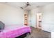 Neutral bedroom featuring an ensuite bathroom, dresser, and ceiling fan at 9963 Hartford Maroon Rd, Orlando, FL 32827