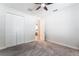 Clean bedroom featuring a ceiling fan, closet space, and neutral carpet at 9963 Hartford Maroon Rd, Orlando, FL 32827