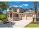 Inviting two-story home featuring a front porch and a two-car garage at 9963 Hartford Maroon Rd, Orlando, FL 32827