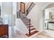 Bright foyer showcasing tile floors, staircase with decorative iron railing, and an open design at 9963 Hartford Maroon Rd, Orlando, FL 32827