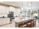 Modern kitchen featuring an island with barstool seating and sleek appliances at 9963 Hartford Maroon Rd, Orlando, FL 32827