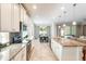 Modern kitchen features stainless steel appliances, granite countertops, and an open layout to the dining area at 9963 Hartford Maroon Rd, Orlando, FL 32827