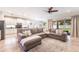 Cozy living room with a large sectional sofa and an open view to the modern kitchen at 9963 Hartford Maroon Rd, Orlando, FL 32827