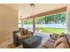 Covered patio featuring comfortable outdoor furniture and a view of the lush green backyard at 9963 Hartford Maroon Rd, Orlando, FL 32827