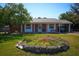 Charming single-story brick home featuring a well-maintained front yard, carport, and classic architectural details at 1 Cosmos Dr, Orlando, FL 32807