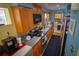 Functional kitchen design with modern appliances, wooden cabinets, and sufficient counter space for easy meal preparation at 1 Cosmos Dr, Orlando, FL 32807