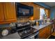Efficient kitchen layout with sleek appliances, tile backsplash, and ample cabinet space for cooking convenience at 1 Cosmos Dr, Orlando, FL 32807