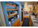 Well-equipped kitchen with stainless steel refrigerator, wooden cabinetry, and direct access to the adjacent dining area at 1 Cosmos Dr, Orlando, FL 32807