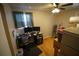Functional office space with hardwood floors, desk, and boxes at 1 Cosmos Dr, Orlando, FL 32807
