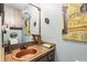 Half bathroom with custom sink, vintage artwork, and framed mirror at 1005 Love Ln # 25, Apopka, FL 32703