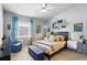 Inviting bedroom featuring a comfortable queen size bed, accent chair and light blue walls at 1005 Love Ln # 25, Apopka, FL 32703