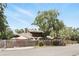Exterior home view featuring a large tree in front, a fence and mature landscaping at 1005 Love Ln # 25, Apopka, FL 32703