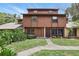 Two-story townhome featuring a well-maintained lawn and a symmetrical walkway leading to the front doors at 1005 Love Ln # 25, Apopka, FL 32703